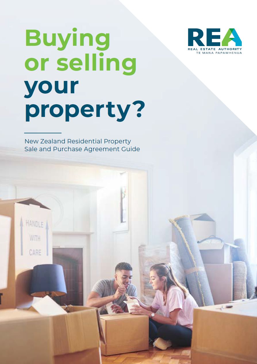 Front cover of Buying or Selling Your Property booklet with couple sitting on floor, eating, in a room surrounded by moving boxes.