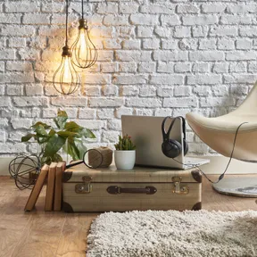 lounge scene with laptop sitting on old suite case with books